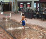 Boy enjoying water during heatwave event